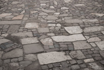 old vintage road. paving stones sidewalk. gray paving stones background.