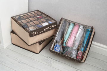 The drawer is divided into cells of different sizes, for separate storage of linen and fabrics. Home storage system for storing clothes. Folding boxes in a set have different shapes.