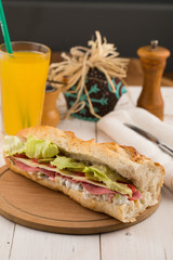 salami and cheese sandwich with orange juice