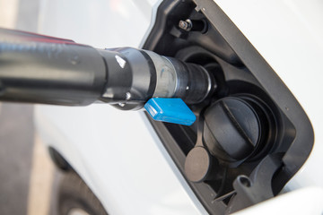 Filling the tank of an eco-car with compressed natural gas.