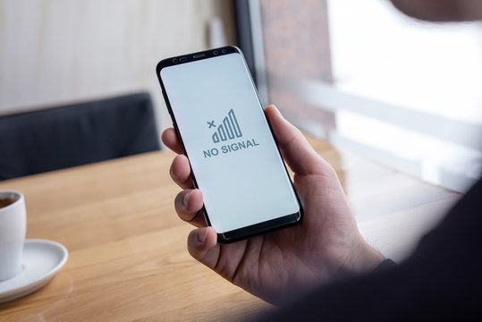 No mobile network signal on smar phone display in man hand. The concept of mobile network loss due to system failure