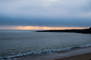 Picture of a seascape during sunset over the Atlantic Ocean, taken during winter.