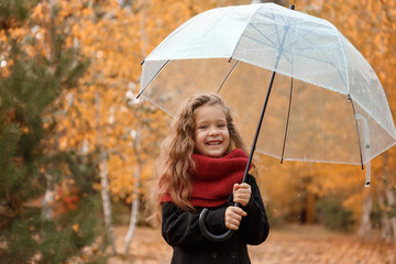 little girl in the rain in a red scarf