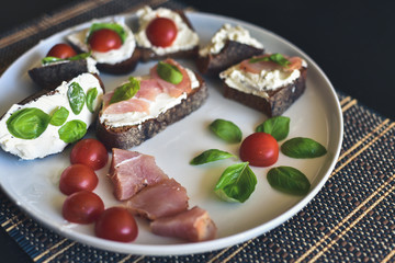 Sandwiches with ham, basil and tomatoes