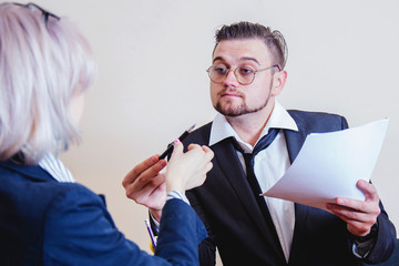 Portrait of cunning businessman is waiting for a contract to be signed. The concept of deception.