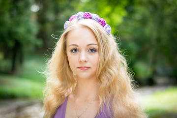 Portrait of a beautiful blonde girl with a wreath on her head.