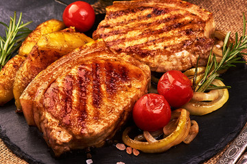 Roasted juicy pork steak with vegetables, fried meat, isolated on white background
