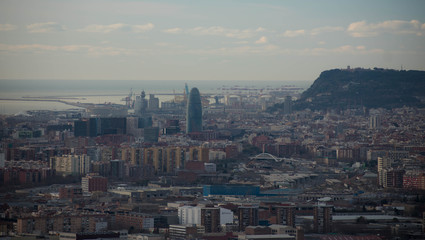 views of barcelona with the aigbar tower and the port in the background