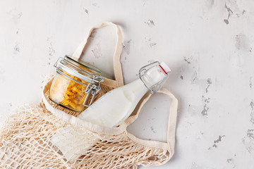 Zero waste, plastic-free and eco-friendly lifestyle. Cotton mesh bag, glass bottle and jar for...