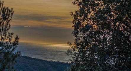 sunrise on the beach from the distance of the mountain