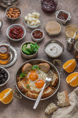 Fried eggs with tomato and different appetizers, turkish breakfast