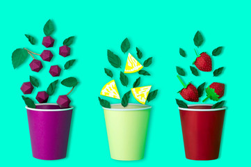 Paper berries, fruit slices and mint leaves fall in paper cup
