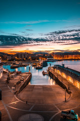 The sun rises at dawn from the port of San Sebastian city. Basque Country