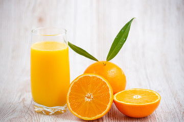Natural fresh fruit oranges in a wooden background backdrop, half cut oranges, orange juice, vitamin C, for good health everyday