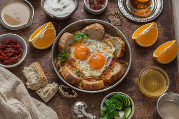 Close view of fried eggs in a traditional turkish pan