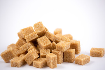 Brown sugar on a white background, healthy sugar used for cooking or desserts.