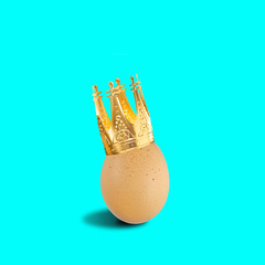 Easter egg decoration golden crown turquoise blue background