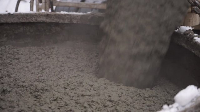 process of pouring concrete into containers