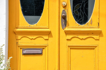 Detail of a beautiful yellow old wooden door in St. John's, Newfoundland.