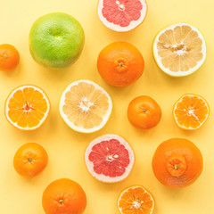 Fresh citrus fruit on yelllow background, flat lay, top view