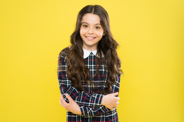 Fashion portrait of girl. happy childhood concept. little fashion model yellow wall. her hair is...