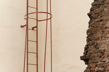 Urban detail of lines and color: exposed bricks, wall ladder and exterior walls