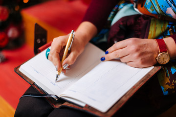 Woman writing the notes in notebook