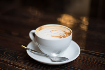 Cup of coffee latte on old wooden background