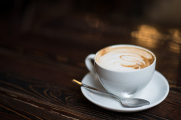 Cup of coffee latte on old wooden background