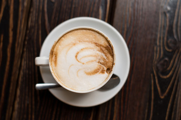 Cup of coffee latte on old wooden background