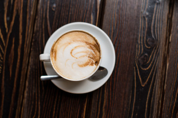 Cup of coffee latte on old wooden background