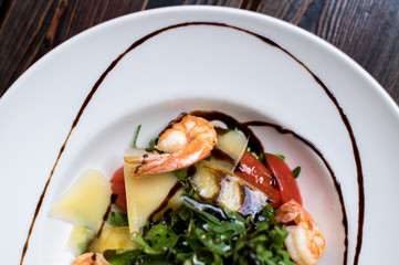 Grilled shrimps and fresh green salad served for lunch