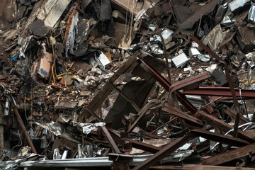 View of construction waste, concrete debris with reinforcement and pieces of metal,  after the destruction of the building
