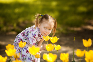 happy beautiful girl 4 years old with tails in the Park earlier spring