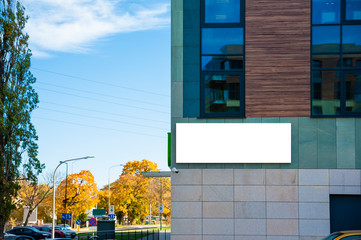 Blank white advertising banner on the wall of modern building © diesirae