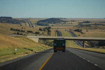 Motorway in South Africa, between Johannesburg and Durban on a clear sunny day, with a bridge coming up.