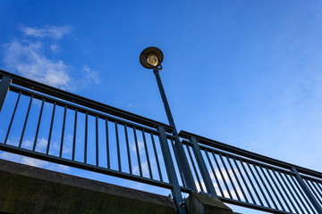 Streetlight against blue sky, view from below 