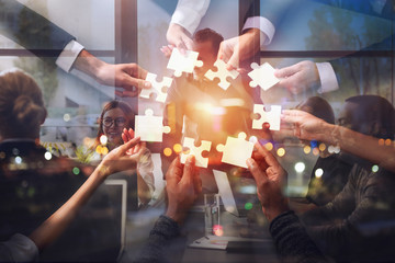 Teamwork of partners. Concept of integration and startup with puzzle pieces. Double exposure