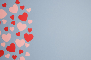 Paper hearts on blue background. For Happy Women's, Mother's, Valentine's Day, birthday greeting card design