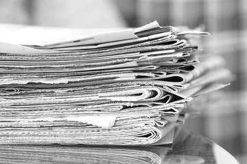 Newspapers Stacked in Pile. Pages with News on Table. Magazines with Headlines and Articles in...