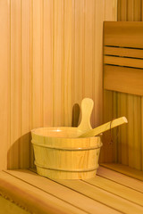 Obraz na płótnie Canvas Sauna interior room. Interior details Finnish sauna steam room with traditional sauna accessories basin scoop. Relax in hot sauna. 
