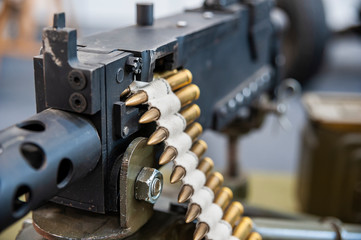Closeup of loaded machine gun with ammunition belt