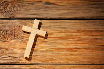 Christian cross on wooden background