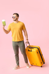 Handsome male tourist on color background