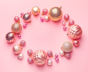 Frame made of beautiful Christmas balls on pink background