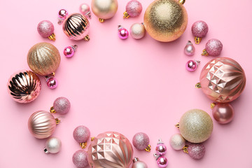Frame made of beautiful Christmas balls on pink background