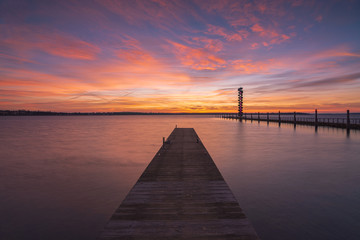 Fototapeta na wymiar Soft and colorful sunrise at the pier