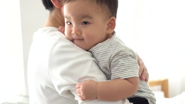 Happy Asian father and baby boy toddler at home, enjoying family time together