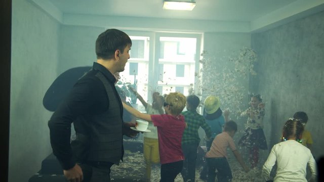 Children made a complete mess in the apartment, and dad calmly drinks coffee.