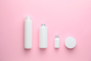 Different cosmetic products on color background